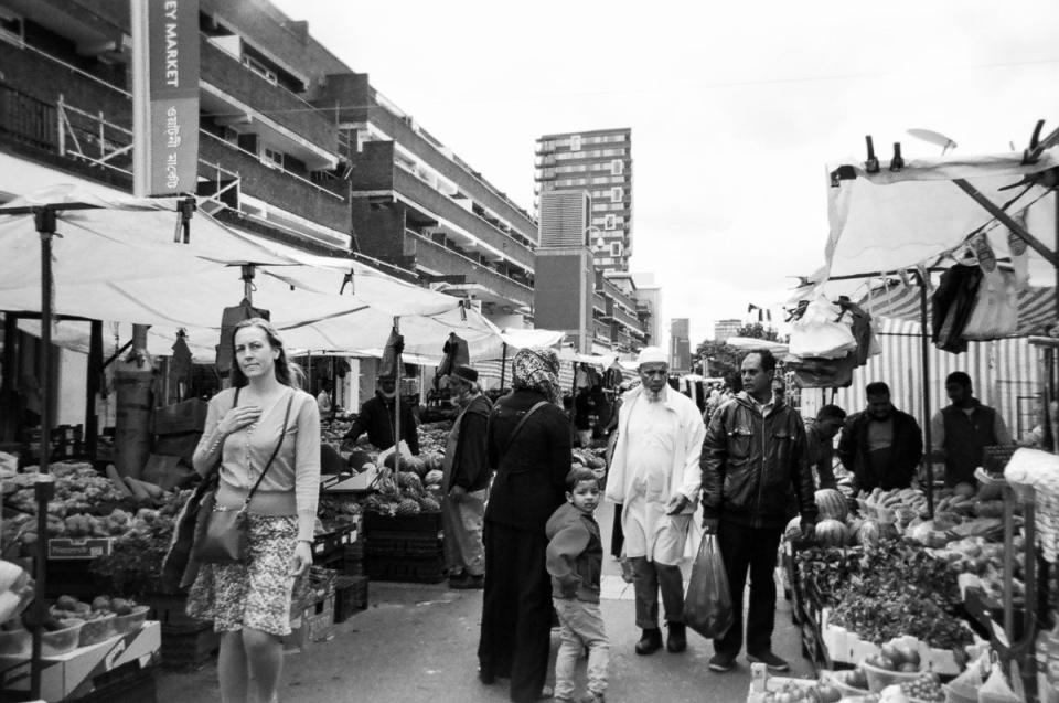 Shoppers browse the produce at a London street market. (Cafe Art/SWNS)