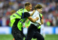 Soccer Football - World Cup - Final - France v Croatia - Luzhniki Stadium, Moscow, Russia - July 15, 2018 Stewards catch a pitch invader REUTERS/Dylan Martinez