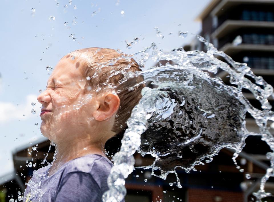 Nathaniel Geiger takes a blast to the face from the splash pad at Imagination Fountain in Cascades Park in Tallahassee, Fla. on Tuesday, Jun 21, 2022, the official first day of summer. 