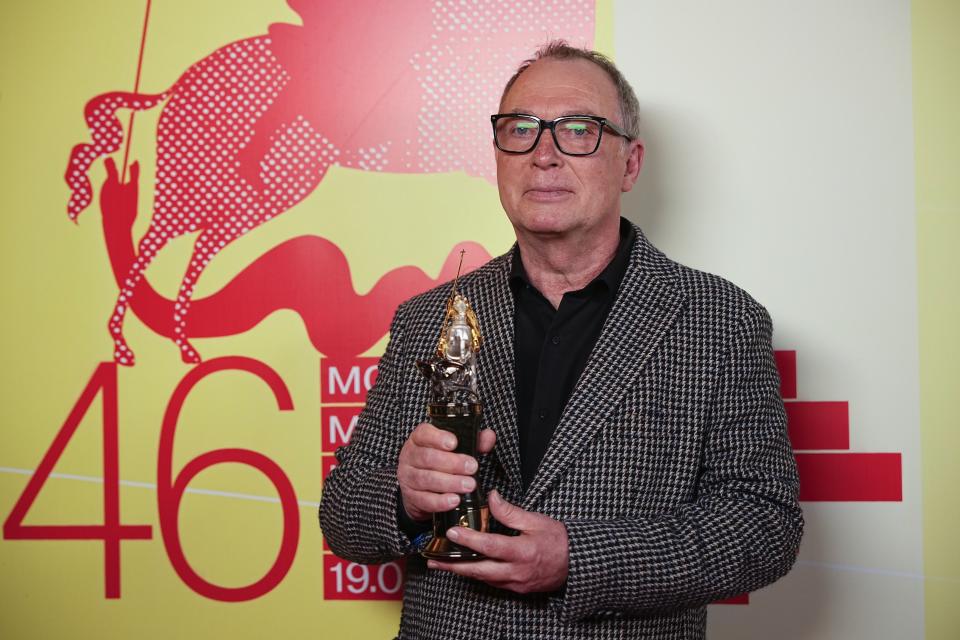 Russian film director Sergei Ursulyak, holds his "The Golden Saint George award for his contribution to cinema posing for a photo after at the closing ceremony of the 46th Moscow International Film Festival in Moscow, Russia, on Friday, April 26, 2024. (AP Photo/Alexander Zemlianichenko)