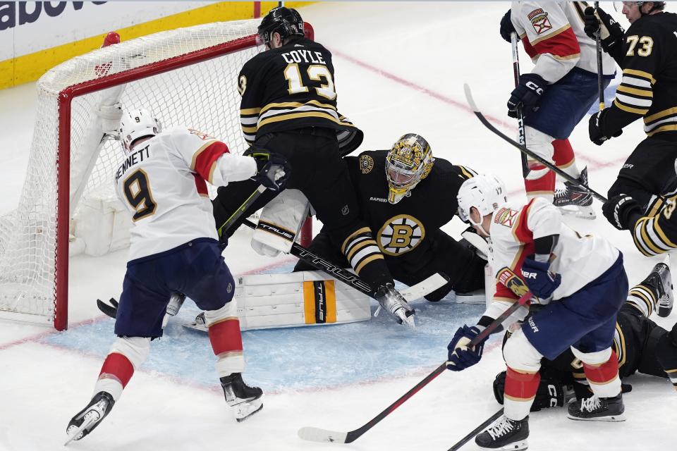 Florida Panthers' Sam Bennett (9) scores against Boston Bruins' Jeremy Swayman (1) as Bruins' Charlie Coyle (13) defends during the third period in Game 4 of an NHL hockey Stanley Cup second-round playoff series, Sunday, May 12, 2024, in Boston. (AP Photo/Michael Dwyer)