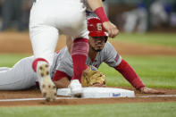 St. Louis Cardinals' Nolan Arenado (28) dives to third base attempting to advance on a fly-out hit by Alec Burleson during the fifth inning of a baseball game, Wednesday, June 7, 2023, in Arlington, Texas. Arenado was tagged out on the play by Texas Rangers third baseman Josh Jung. (AP Photo/Jim Cowsert)