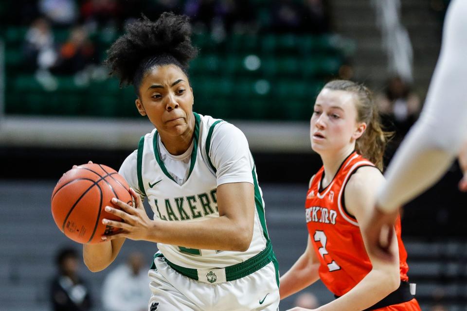 West Bloomfield guard Indya Davis (24) makes a pass against Rockford guard Anna Wypych (2) during the first half of the MHSAA Division 1 girls basketball final at Breslin Center in East Lansing on Saturday, March 18, 2023.