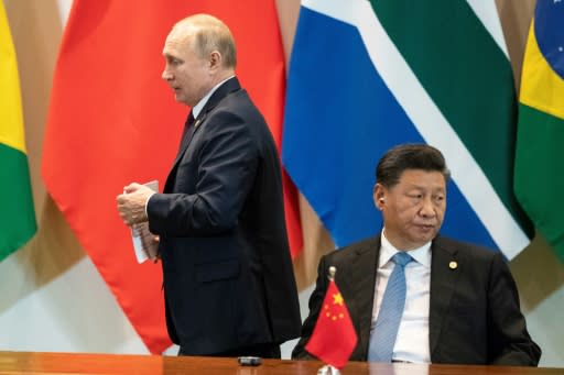 China's President Xi Jinping (R) has called Putin his "best friend"