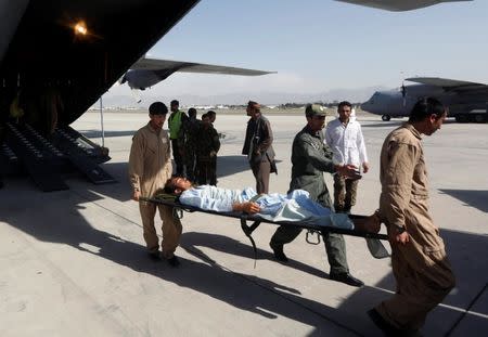 Afghan Air Force medical personnel carry an injured member of the Afghan security forces off a C-130 military transport plane in Kabul, Afghanistan July 9, 2017. REUTERS/Omar Sobhani