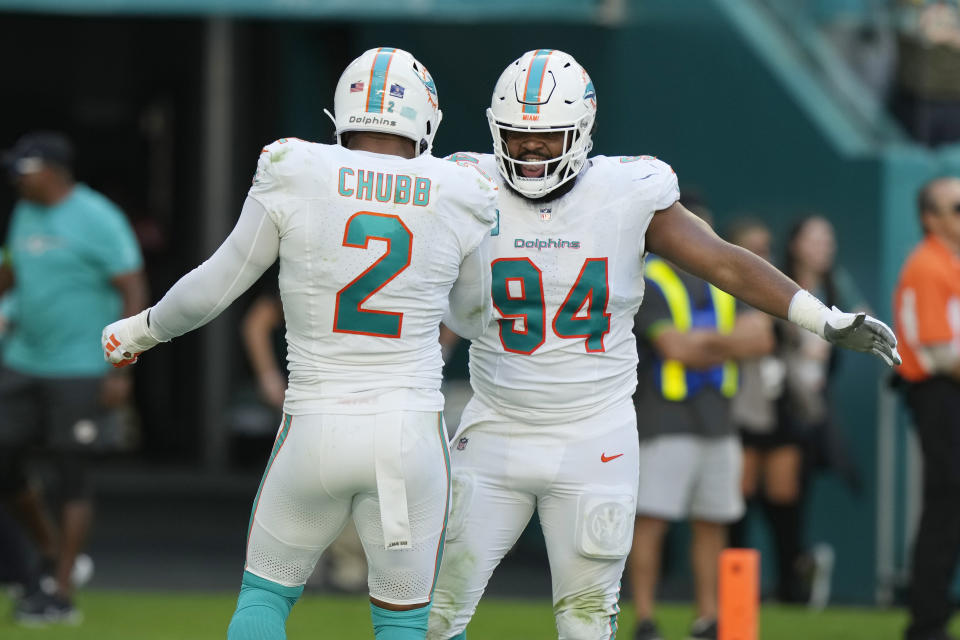 Miami Dolphins defensive tackle Christian Wilkins (94) celebrates a sack by linebacker Bradley Chubb (2) against New York Jets quarterback Zach Wilson (2) during the first half of an NFL football game, Sunday, Dec. 17, 2023, in Miami Gardens, Fla. (AP Photo/Lynne Sladky)