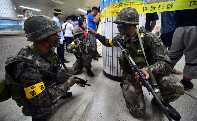 South Korean soldiers take a position during an anti-terror drill on the sidelines of South Korea-US joint military exercise, Ulchi Freedom Guardian, at a metro station in Seoul, in 2015