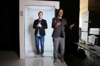 Portl inventor David Nussbaum poses for a photo next to an A.I.-powered life-size hologram of himself in Gardena