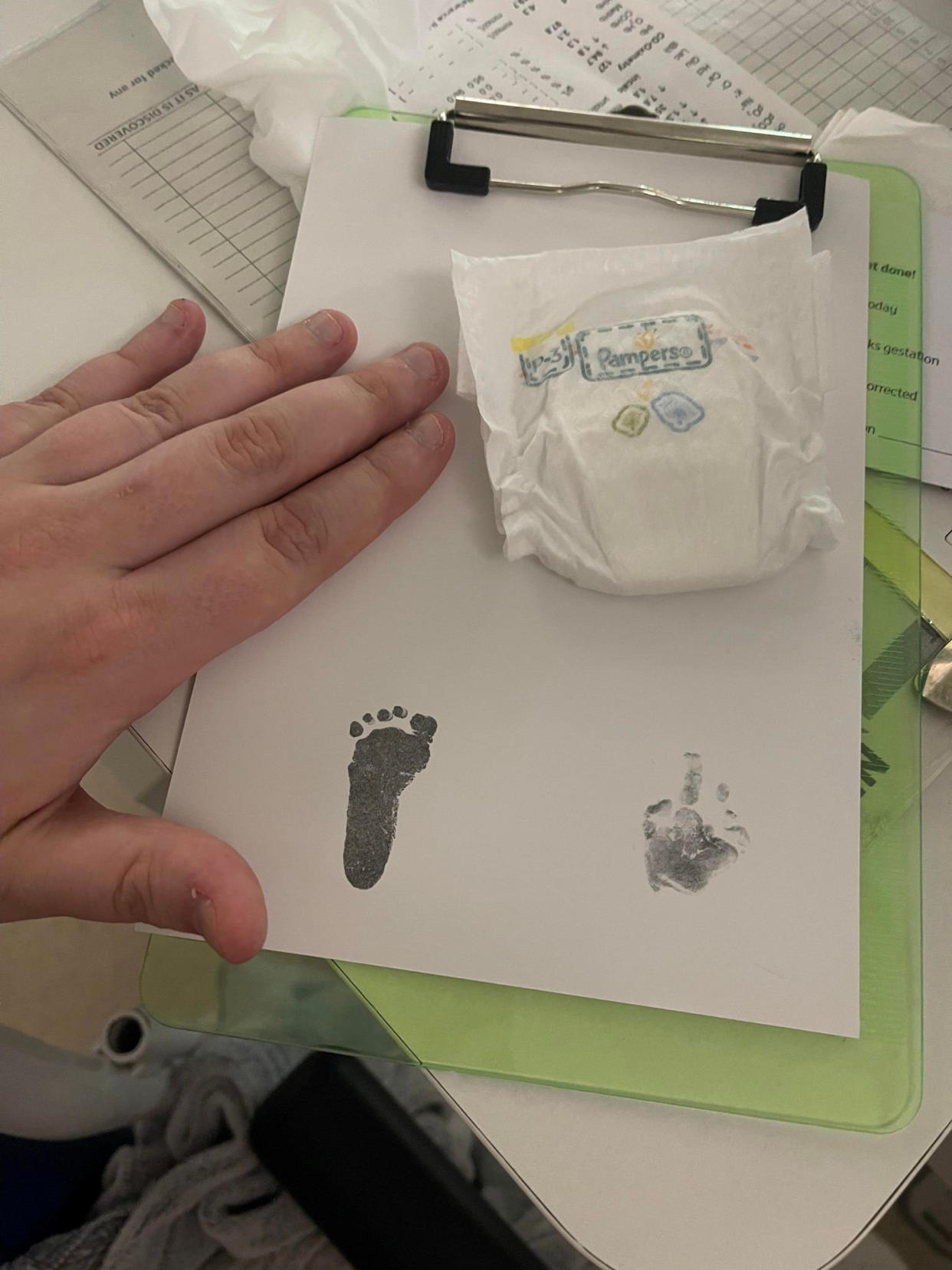 Baby Hannah's tiny nappy and footprint. (SWNS)