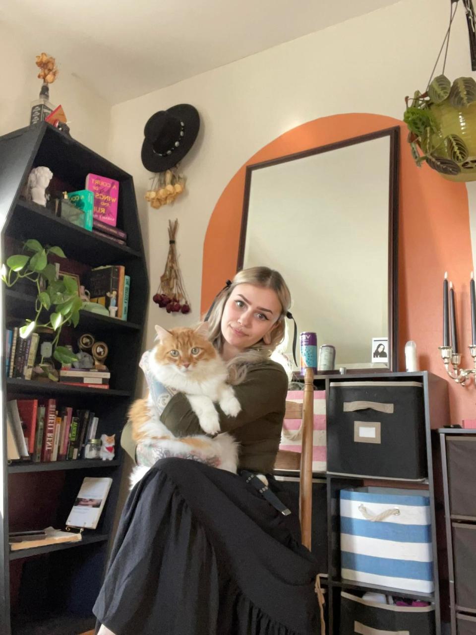Milo Nunes, pictured with their cat Olive, had saved enough to move into an apartment of their own. But they fell victim to a rental scam on Facebook Marketplace.