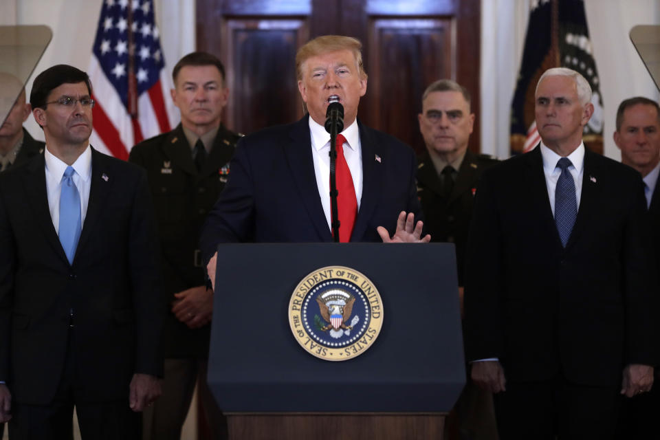 President Donald Trump addresses the nation from the White House on the ballistic missile strike that Iran launched against Iraqi air bases housing U.S. troops, Wednesday, Jan. 8, 2020, in Washington, as Secretary of Defense Mark Esper, Chairman of the Joint Chiefs of Staff Gen. Mark Milley, and Vice President Mike Pence, and others look on. (AP Photo/ Evan Vucci)