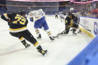 Buffalo Sabres right wing Kyle Okposo (21) and Boston Bruins right wing David Pastrnak (88) battle for possession of the puck during the second period of an NHL hockey game Friday, Oct. 22, 2021, in Buffalo, N.Y. (AP Photo/Joshua Bessex)
