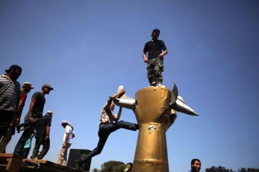 Libyan rebels gather at the Bab al-Aziziya compound in Tripoli a day after it was captured by anti-Kadhafi forces