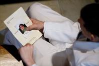 <p>A mourner looks through a program before the funeral service for Christopher Andrew Leinonen, one of the victims of the Pulse nightclub mass shooting, at the Cathedral Church of St. Luke, June 18, 2016, in Orlando, Fla.. (AP Photo/David Goldman) </p>