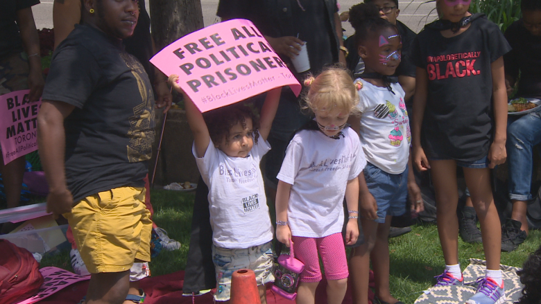 Children in superhero capes protest with Black Lives Matter outside U.S. Consulate