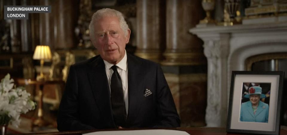 King Charles III sits in Buckingham Palace during a pre-recorded speech.
