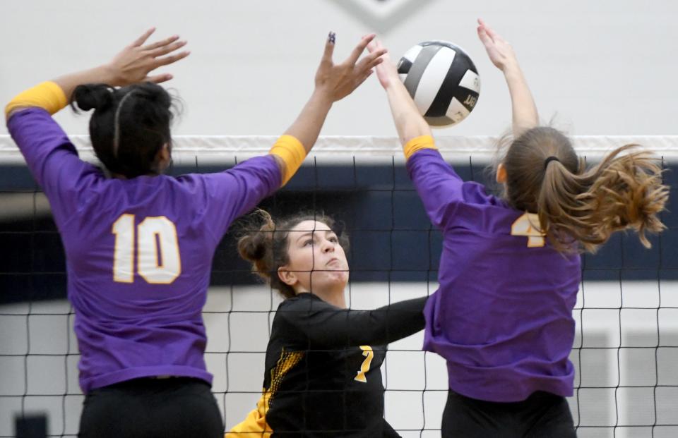 A Perry Brooke Jannelli hit is blocked by Jackson's Leigh James and Taylor Brownsword in the second set of DI Girls Volleyball District Final at Hudson High School. Thursday, Oct. 26, 2023.