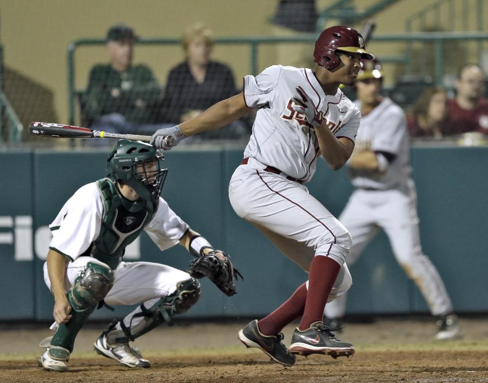 Florida State designated hitter Jameis Winston follows his ground out to second base during the eighth inning of an NCAA college baseball game against South Florida Tuesday, March 4, 2014, in Tampa, Fla. Catching for South Florida is Levi Borders. (AP Photo/Chris O'Meara)
