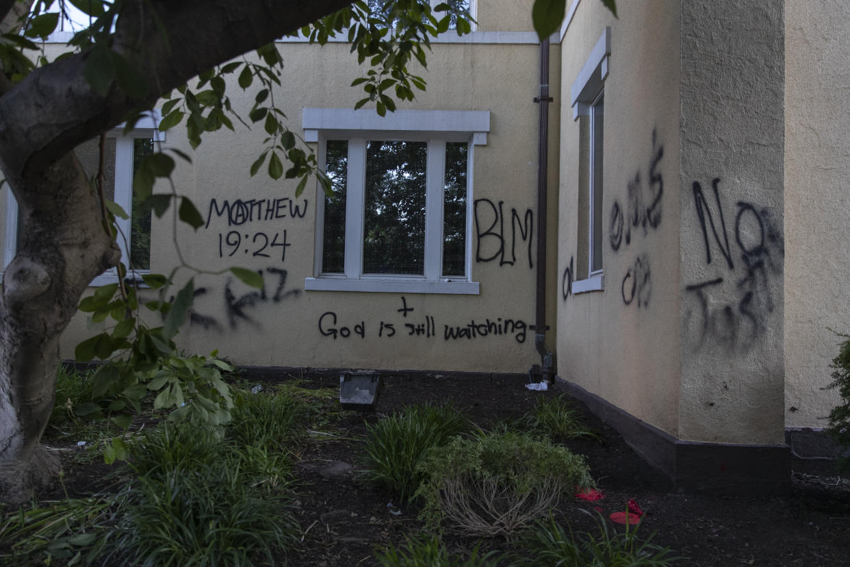 Graffiti says "God is still watching" on the exterior walls of St. John's Episcopal Church near the White House on June 1, 2020, after a night of protests over the death of George Floyd. (Photo: AP Photo/Carolyn Kaster)