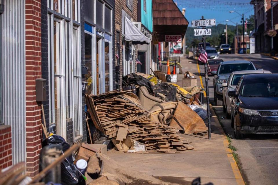 Furniture, carpet and wood damaged by flash flooding sit outside businesses in downtown Whitesburg, Ky., on Thursday, Aug. 4, 2022.