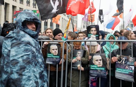 People attend a rally to demand the release of jailed protesters in Moscow