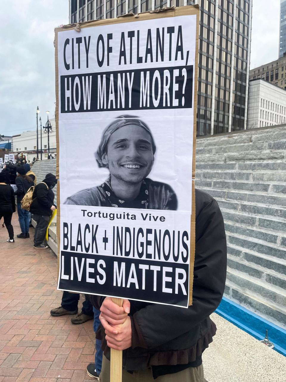 A demonstrator holds a sign protesting the death of an environmental activist known as Tortuguita in Atlanta in January 2023. Tortuguita was killed on Jan. 18, 2023, after authorities said the 26-year-old shot a state trooper. Activists questioned officials’ version of events, demanding an independent investigation.