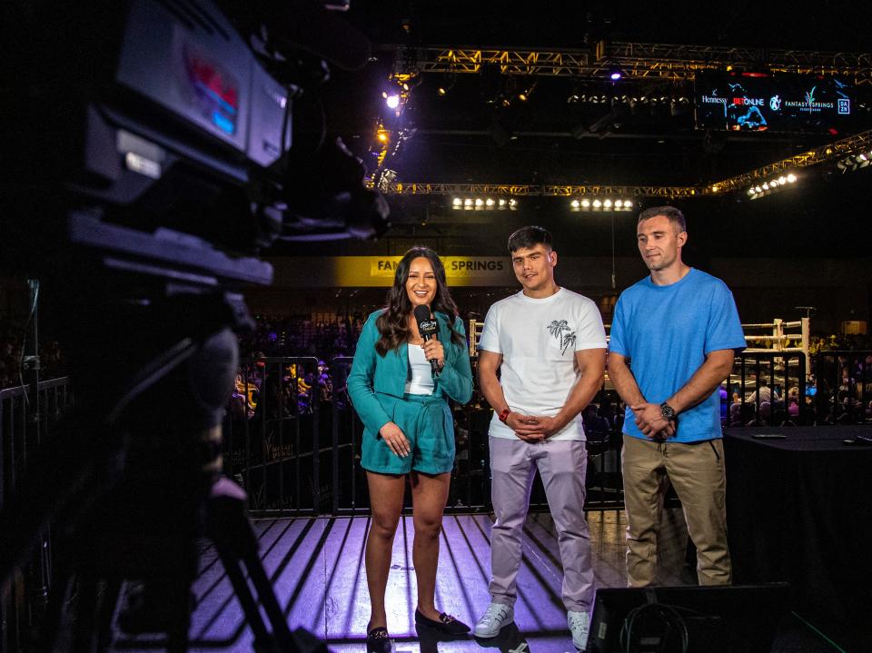 Sports anchor Brandy Flores interviews Bektemir Melikuziev (middle) and Aliko Frolov (right) between rounds at Fantasy Springs Resort Casino in Indio on Thursday.