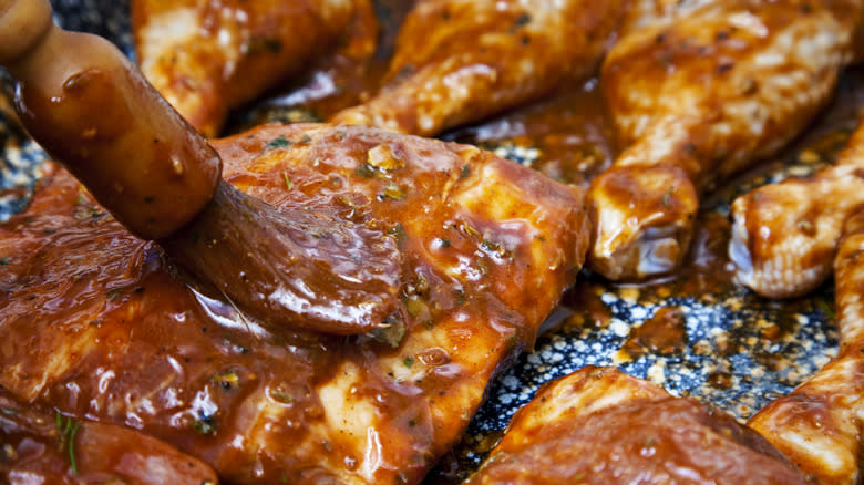 meat being brushed with marinade