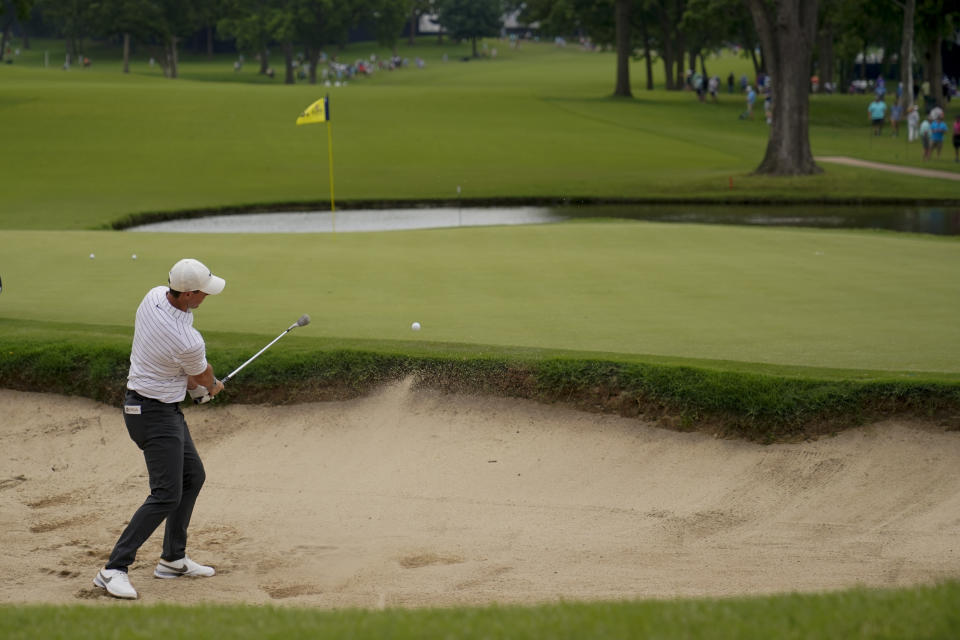 Rory McIlroy, of North Ireland, hits from the bunker on the 13th hole during a practice round for the PGA Championship golf tournament, Tuesday, May 17, 2022, in Tulsa, Okla. (AP Photo/Sue Ogrocki)