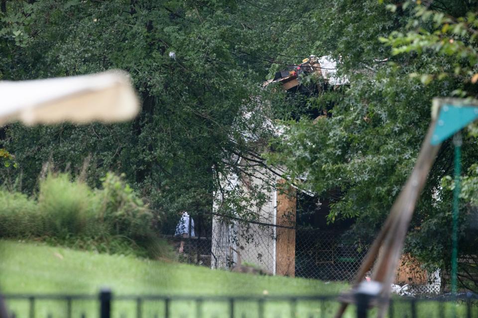 Debris from a small plane crash sets in backyards of a residential neighborhood in Upper Moreland, Pa., Thursday, Aug. 8, 2019.