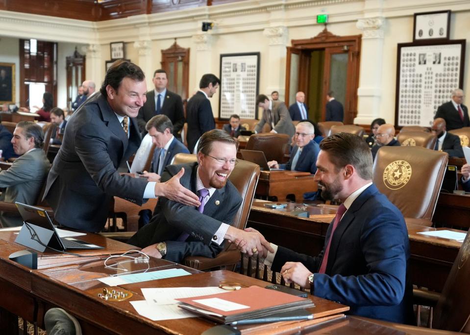 Rep. Jeff Leach, R - Plano, right, is congratulated by Rep. Craig Goldman, R - Fort Worth, left, and Rep. Will Metcalf, R - Conroe, middle, after the House voted for SB 7, which would ban COVID vaccine mandates, at the Capitol on Wednesday October 25, 2023.