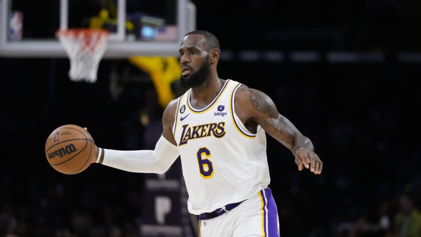 Los Angeles Lakers' LeBron James dribbles during the second half of an NBA basketball game against the Washington Wizards Sunday, Dec. 18, 2022, in Los Angeles. (AP Photo/Jae C. Hong)