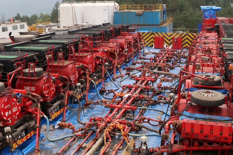 FILE PHOTO: Fracking trucks at work are seen at a shale gas well of Sinopec in Nanchuan, Chongqing
