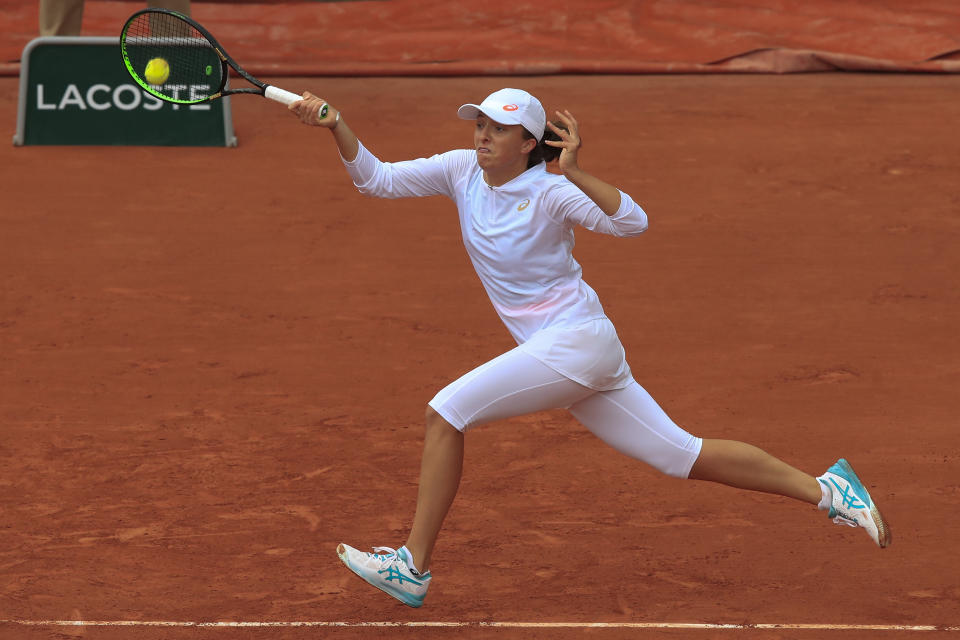 Poland's Iga Swiatek plays a shot against Canada's Eugenie Bouchard in the third round match of the French Open tennis tournament at the Roland Garros stadium in Paris, France, Friday, Oct. 2, 2020. (AP Photo/Michel Euler)