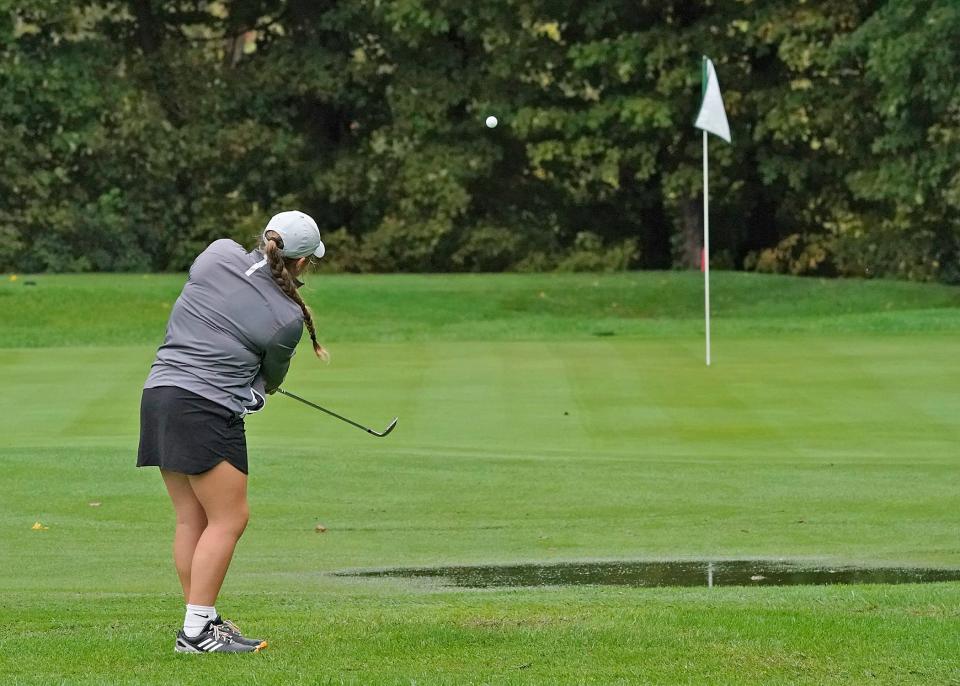 Clinton's Kyleigh Ramos chips over a puddle and onto the green at the Hills of Lenawee Monday during the Division 4 regional meet.