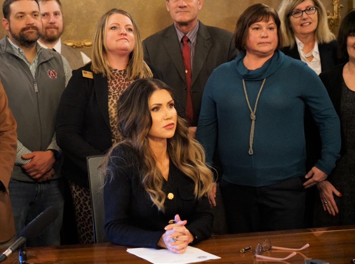 Gov. Kristi Noem signs a bill about employee contribution rates into law in the Capitol Building on Feb. 1. It's the first law signed into the books during the 2023 Legislative Session.