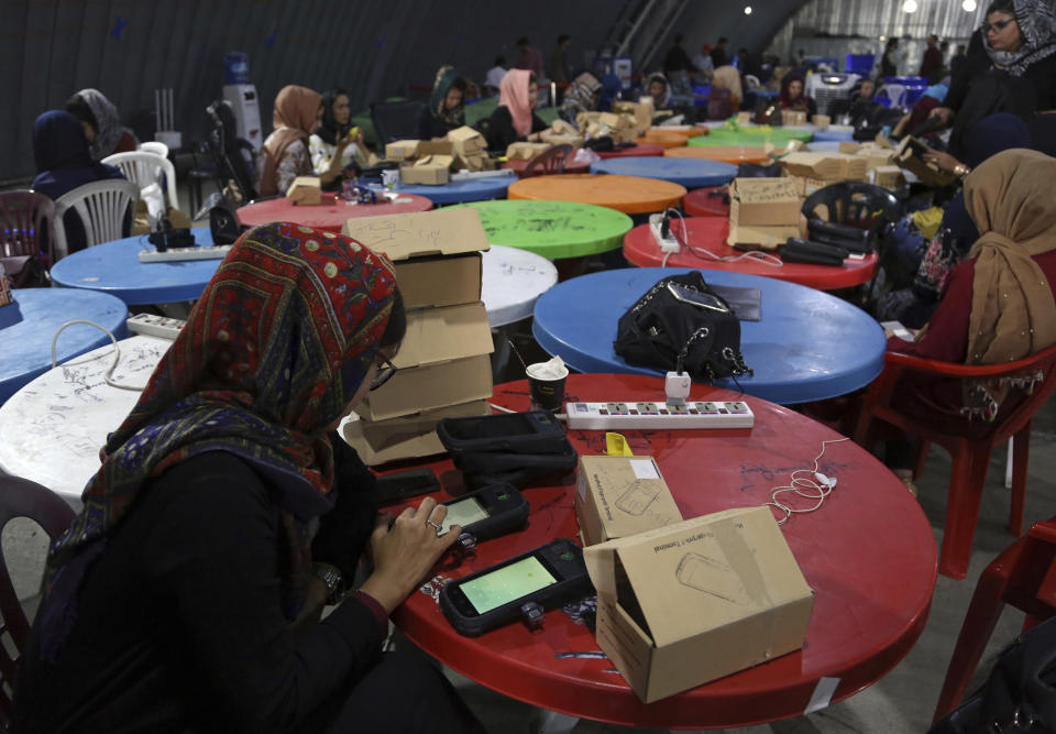 Election commission workers check biometric devices in preparation for the presidential election scheduled for Sept 28, at the Independent Election Commission compound in Kabul, Afghanistan, Sunday, Sept. 15, 2019. Afghan officials say around 100,000 members of the country's security forces are ready for polling day. (AP Photo/Rahmat Gul)