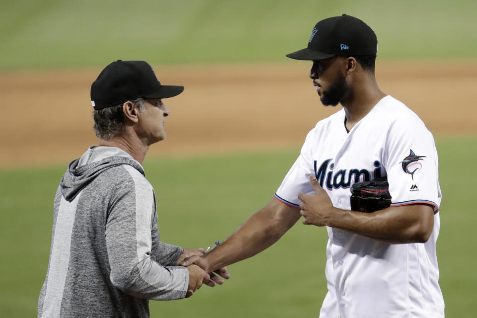 Miami Marlins manager Don Mattingly, left, shakes hands with starting pitcher Sandy Alcantara after a baseball game against the Kansas City Royals, Sunday, Sept. 8, 2019, in Miami. Alcantara pitched a complete game as the Marlins won 9-0. (AP Photo/Lynne Sladky)wbb