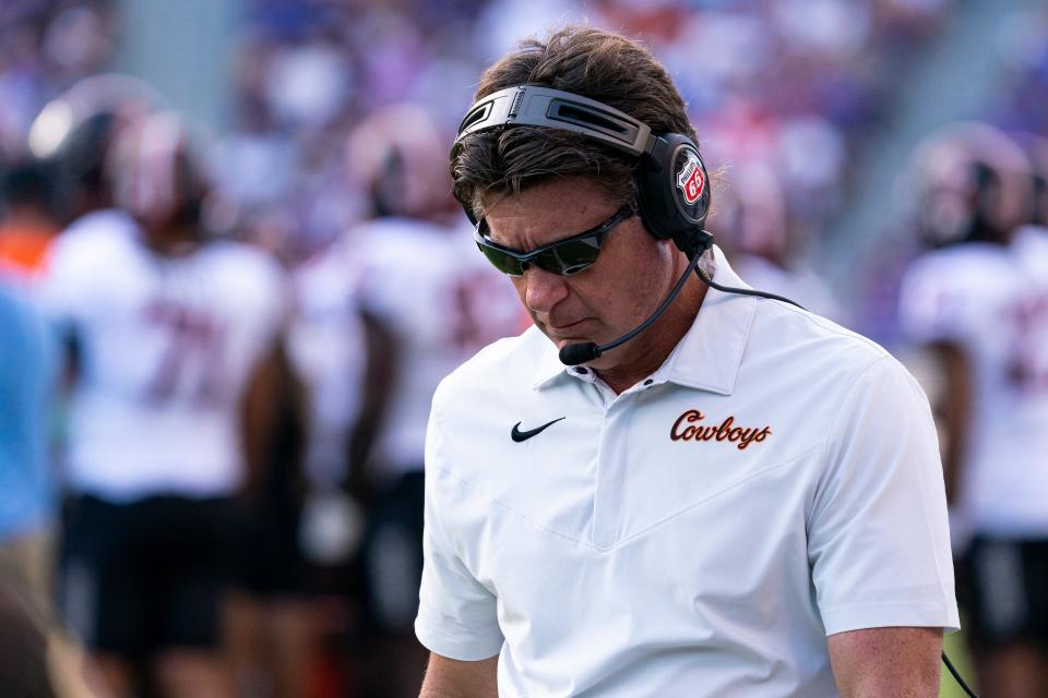 Oklahoma State head coach Mike Gundy walks on the field during the second half of an NCAA college football game against TCU in Fort Worth, Texas, Saturday, Oct. 15, 2022. (AP Photo/Sam Hodde)