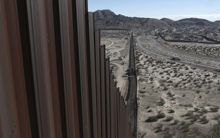 A truck drives near the Mexico-U.S. border fence, on the Mexican side, separating the towns of Anapra, Mexico and Sunland Park, New Mexico. (AP Photo/Christian Torres, File)