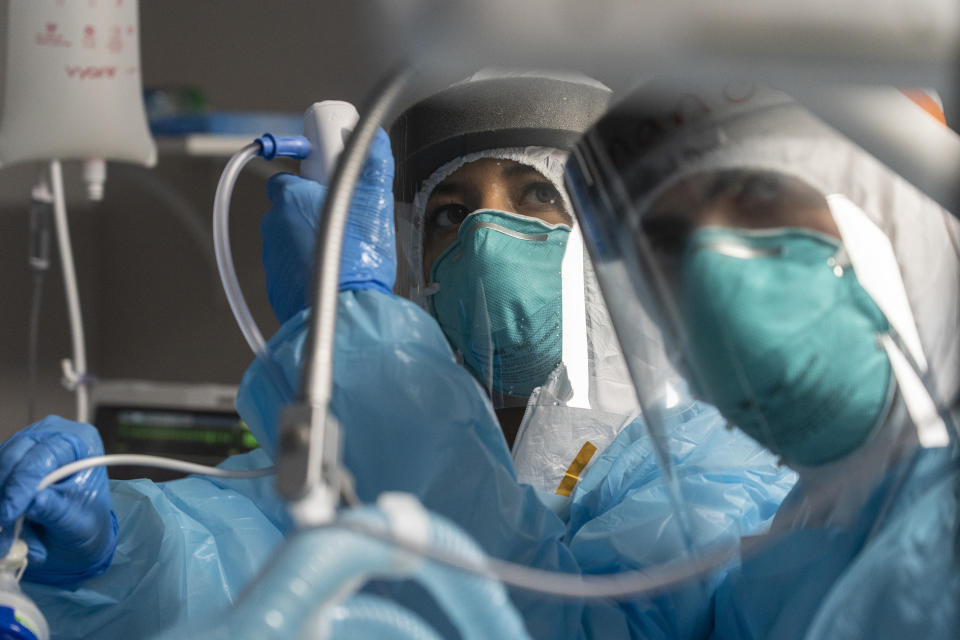 HOUSTON, TX - NOVEMBER 26: (EDITORIAL USE ONLY) Medical staff members monitor an endoscope as they perform percutaneous tracheostomy procedure on a patient in the COVID-19 intensive care unit (ICU) at the United Memorial Medical Center on November 26, 2020 in Houston, Texas. According to reports, Texas has reached over 1,220,000 cases, including over 21,500 deaths. (Photo by Go Nakamura/Getty Images)