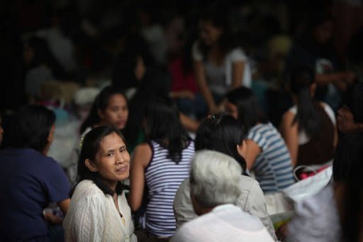 Foreign domestic helpers gather beneath the HSBC building in the Central district of Hong Kong. A court ruling has given them a chance to apply for permanent residency -- but the decision, which has polarised opinions in the southern Chinese city, has also prompted different reactions among maids themselves