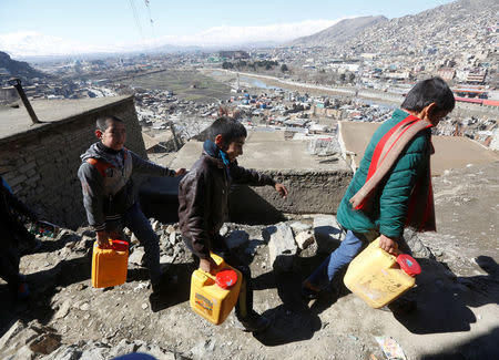 Afghan boys carry water they as they climb a hill in Kabul, Afghanistan February 20, 2017. Picture taken February 20, 2017. REUTERS/Omar Sobhani