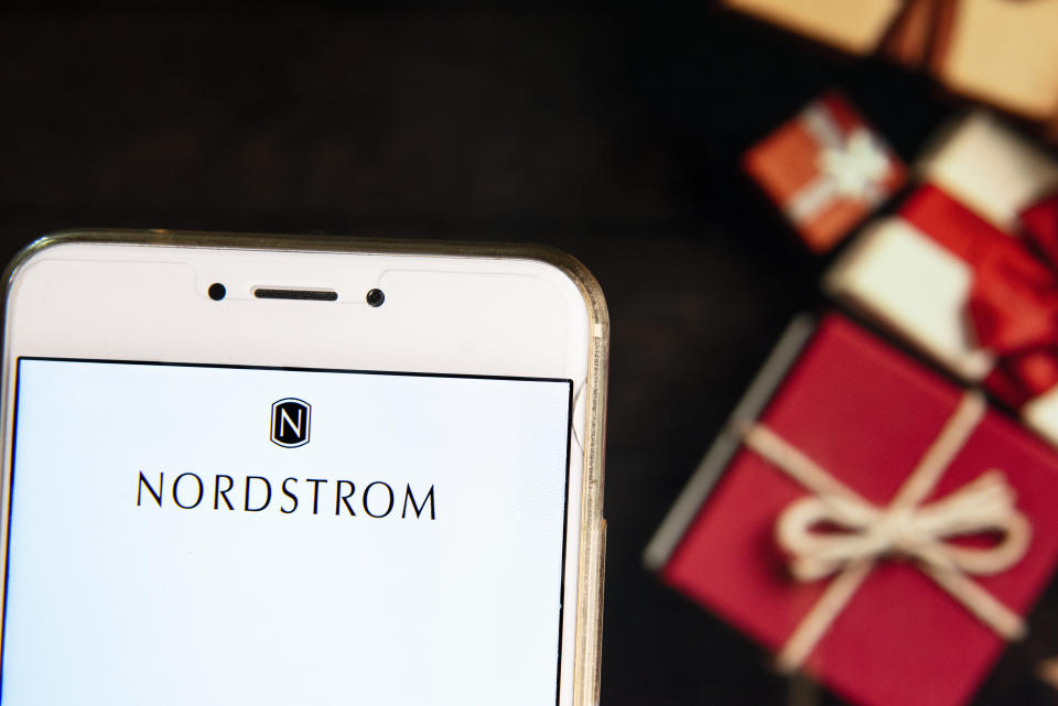 HONG KONG - 2018/11/21:  In this photo illustration, the American chain of luxury jewelry department store company Nordstrom logo is seen displayed on an Android mobile device with a Christmas wrapped gifts in the background. (Photo Illustration by Miguel Candela/SOPA Images/LightRocket via Getty Images)