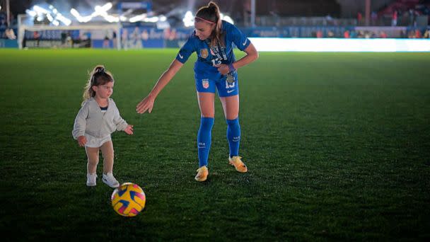 PHOTO: Alex Morgan #13 of the United States kicks a ball with her daughter Charlie after winning the SheBelieves Cup against Brazil at Toyota Stadium on Feb. 22, 2023 in Frisco, Texas. (Andrew Hancock/ISI Photos/Getty Images)