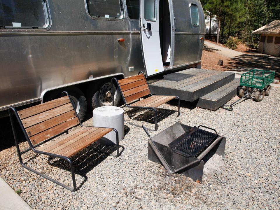 a fire pit next to outdoor seats