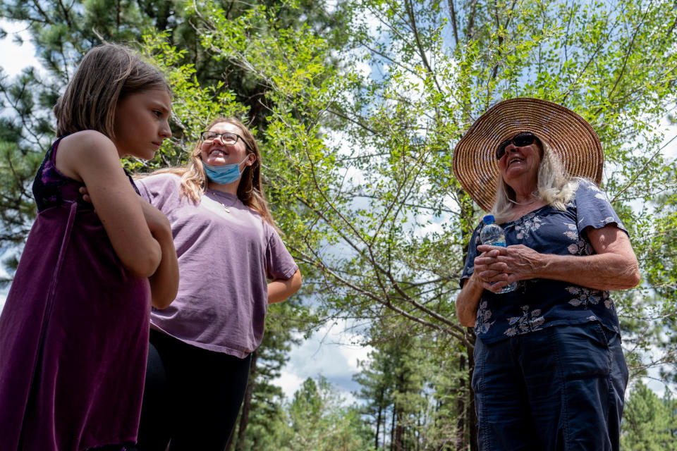 Acelyn Wolf, 10, left, Katherine Cuendet, intern at the Arizona Cancer Support Community, center, and Wendy Petransky, 69, right, diagnosed with malignant melanoma but says it's currently not active, walk along a trail during a forest bathing session with the Arizona Cancer Support Community in Flagstaff on July 21, 2022. Shinrin-yoku, also known as forest bathing, is a Japanese health and wellness practice meant for participants to immerse themselves with the forest atmosphere.