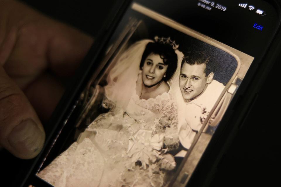 Larry Pfaff holds up a photo of his parents on their wedding day. Pfaff wrote a harsh obituary about his father, who died June 27, describing him as an alcoholic, abusive parent who loved only himself. Those words brought him closure after a lifetime of pain, he said.