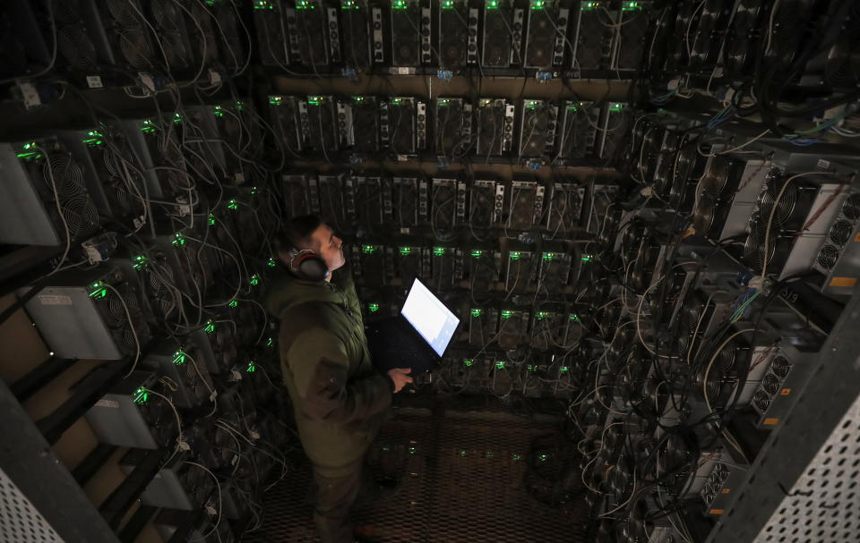 An employee works at the data centre of the BTC KZ crypto mining company located near the coal-fired thermal power plant outside the town of Ekibastuz, Kazakhstan November 6, 2021. Picture taken November 6, 2021. REUTERS/Pavel Mikheyev