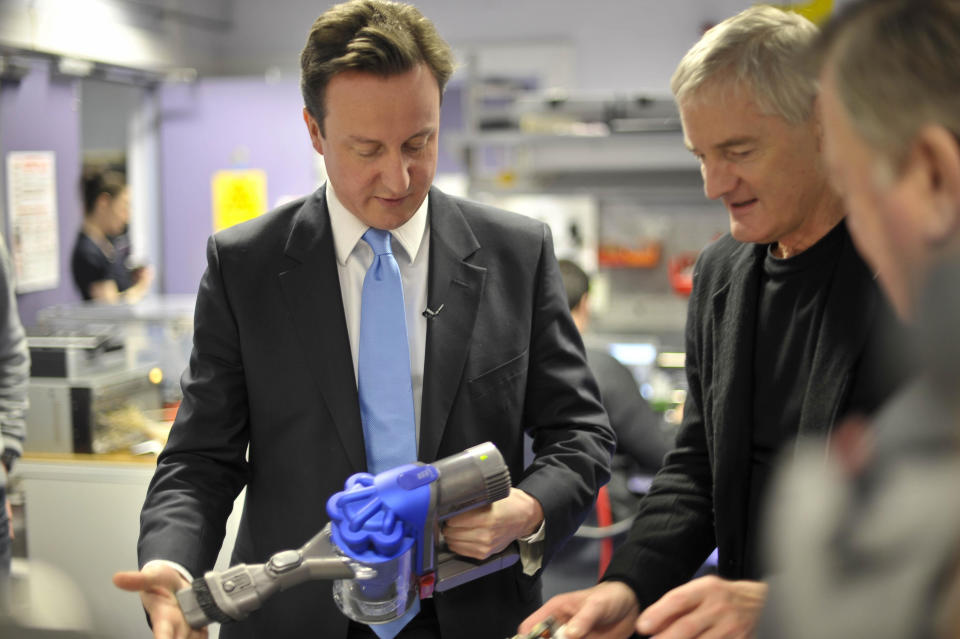 Leader of the Conservatives David Cameron tests the suction of a Dyson battery powered vacuum in the presence of James Dyson at The Dyson factory in Malmesbury, Wiltshire.